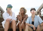 three friends pose for a photo at the beach as they consider the zodiac signs most likely to be in a...